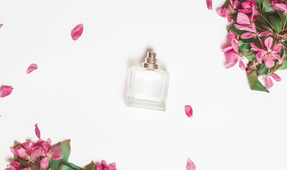 Beautiful composition with perfume and flowers. Perfume bottle, pink flowers on white background. top view. Flat lay. copy space Perfumery cosmetics toilet water fragrance collection