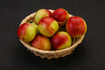 Sweet small nectarines in the basket