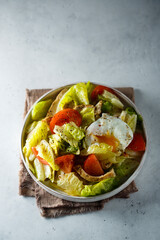 Healthy green salad with chicken and poached egg