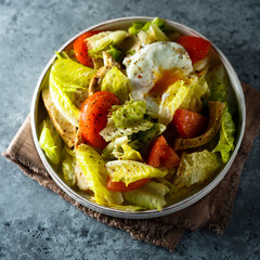 Healthy green salad with chicken and poached egg