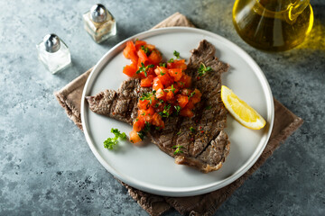 Grilled beef steak with tomato salsa