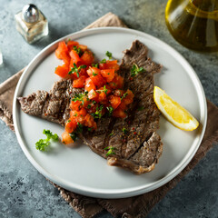 Grilled beef steak with tomato salsa