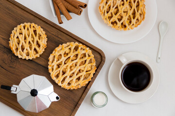 A cup of coffee and apple pie on the table