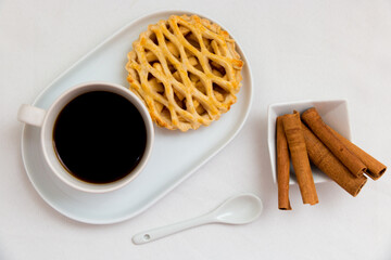 A cup of coffee and apple pie on the table