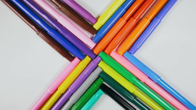 The felt pen spin rotate quickly fast fly, dispart, splash to the sides with centrifugal coriolis force. The video is in reverse. The marker twist, create pattern, make design shape picture.