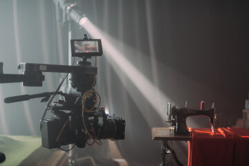 Professional cinema and video camera on the set. Shooting shift, lighting fixtures, shooting equipment and the team.