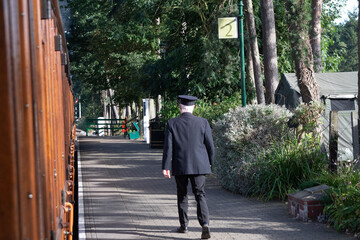 Sheringham, Norfolk, UK - SEPTEMBER 14 2019: Train conductor walks on platform durin 1940s weekend