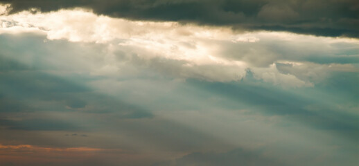 Sunbeams breaking through suggestive dark clouds. No land view.