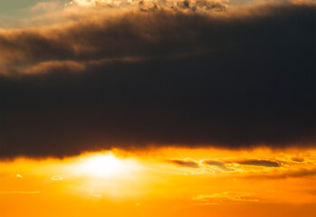 Colorful sunset sky with dramatic dark clouds. Only sky, no land.