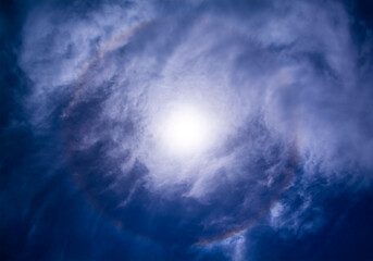 Fototapeta na wymiar The colors of the solar halo hidden by the clouds, view from Sicily, Italy.