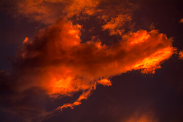 Colorful sunset sky with dramatic orange clouds. Only sky, no land.