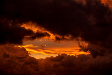 Sunset sky illuminated by orange clouds. Only sky, no earth.