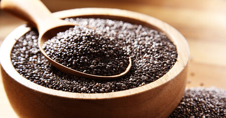 Bowl of chia seeds on wooden table