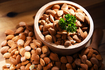 Bowl of apricot kernels on wooden table