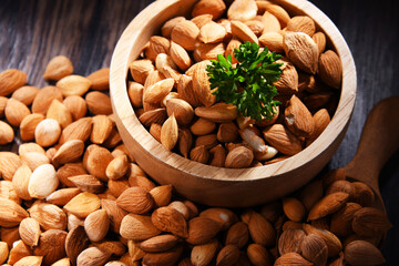 Bowl of apricot kernels on wooden table