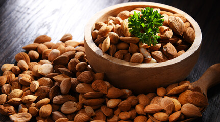 Bowl of apricot kernels on wooden table