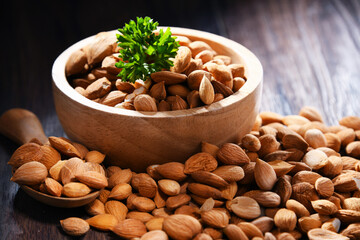 Bowl of apricot kernels on wooden table