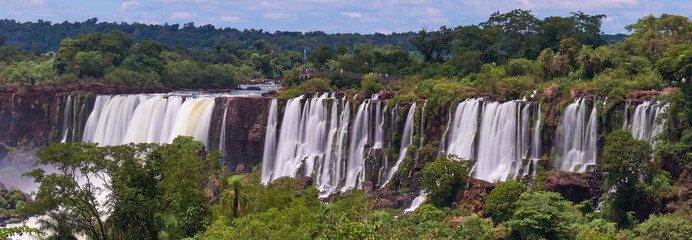 Iguazu waterfalls in Argentina, view from Devil's Mouth. Panoramic view of many majestic powerful...