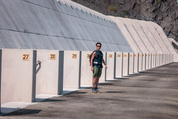 Backpack man standing next to the dam of Plover Cove Reservoir