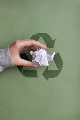 The man throws the crumpled paper into a garbage container. Sorting and recycling of garbage