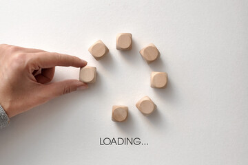 Wooden cubes in the form of an Internet download. The symbol for waiting for something to load