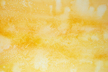 yellow watercolor with white spots. painted textured paper with watercolor paints of different orange color. background or backdrop of abstract art handmade diy painting