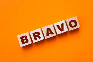 Word BRAVO made with wood building blocks