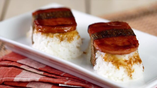 Spam musubi is a popular snack and lunch food in Japan that composed of spam on top of rice wrapped with thick or thin nori