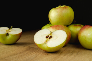 Fresh delicious apples on a wooden kitchen table. Healthy diet food fruits composition.