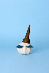 White Halloween pumpkin with make up on the blue background. Minimal Holiday season concept background.