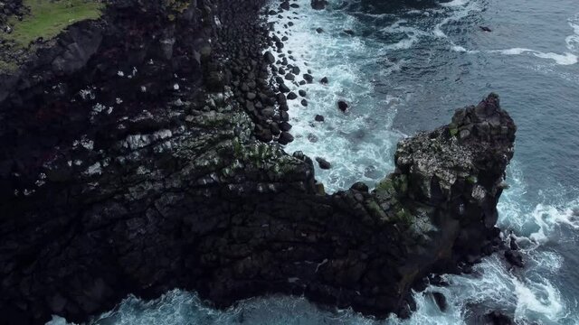 Lighthouse in Iceland on ocean (sea) coast. Aerial drone video of Icelandic landscape. Landmarks destinations in Icelandic nature on Iceland. 4K UHD video. 