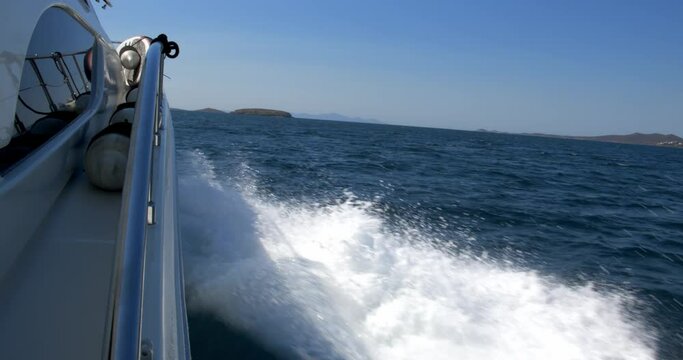View from a fast moving yacht at full power crashing through the waves 