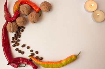 background with pepper, coffee beans, walnuts and burning candles