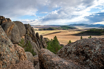 Rocks with pine trees against the sky, spring