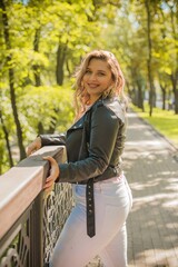 Young stylish woman walking on the city street. Casual fashion. Plus size model. Happy overweight woman walking the city streets