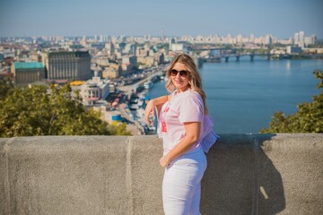 Young stylish woman walking on the city street. Casual fashion. Plus size model. Happy overweight woman walking the city streets