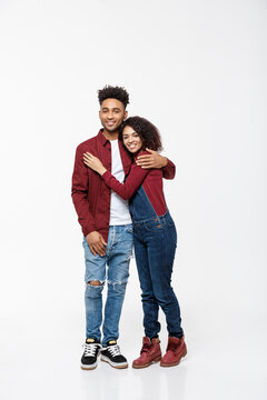 Full Body Portrait Of Young African American Hugging Couple, With Smile. Dating, Flirting, Lovers, Romantic Studio Concept, Isolated On White Background.