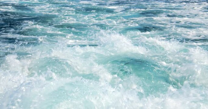 Great closeup up slow motion shot of the wake of a large ship in crystal clear waters