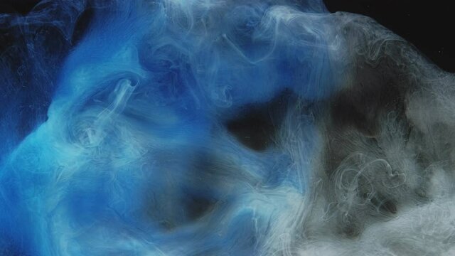 Color smoke puff. Logo reveal. Ink water drop. Vapor splash animation. Blue white fume cloud mix motion on black abstract background with floating glitter dust particles.