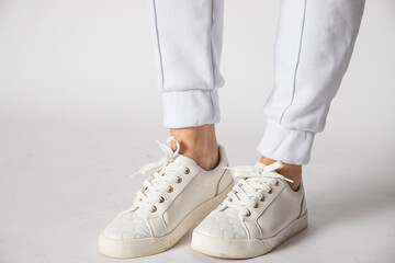 Fashionable women's white leather sneakers. Stylish shoes. Casual design. Beautiful boots for all weather conditions. casual clothes