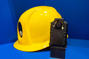 Construction helmet with built-in video camera. Devices for video recording during construction. Equipment for video filming at the construction site. Builder helmet with CCTV camera