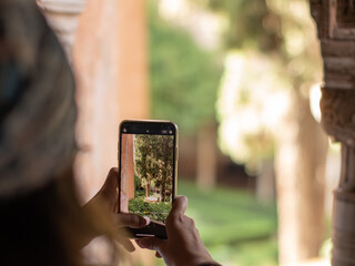 Girl photography of a green garden with a mobile phone