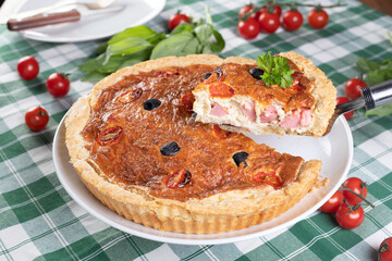 French cheese pie with sausages and cherry tomatoes.