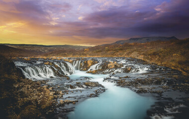 Colorful sunset at the Bruarfoss waterfall in south Iceland  with blue water