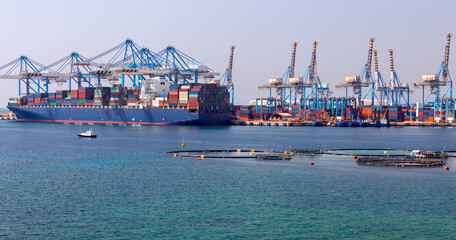 A large container ship is loaded in the cargo port of Malta.