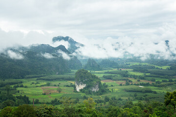 Obraz premium Unseen place in Thailand - a beautiful view of mountain range with greenery forest and misty environment in the morning time. Relaxation with nature view, scenic photo seen.
