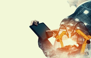 Mechanized industry robot arm and factory worker double exposure . Concept of robotics technology for industrial revolution and automated manufacturing process .