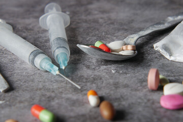 drug addiction concept with heroine packet and syringe on black backgrund 