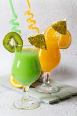 Backgrounf with fresh orange and kiwi juice 