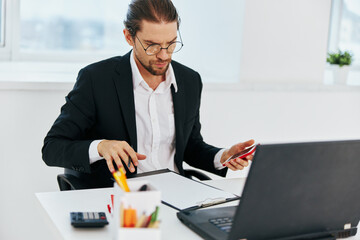 man in a suit documents work office laptop executive